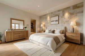 Bedroom featuring recessed lighting, tile walls, an accent wall, and light wood-type flooring