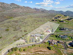 Aerial overview of property's location featuring property parcel outlined and a mountain backdrop