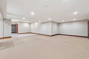 Spare room with recessed lighting and light carpet
