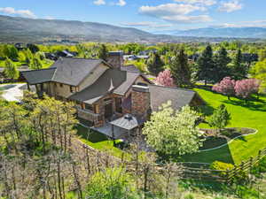 Aerial view of property and surrounding area featuring mountains