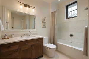 Bathroom with vanity and shower / bath combo with shower curtain