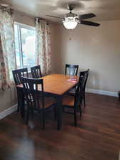 Dining space with wood finished floors, baseboards, and a ceiling fan
