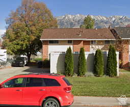 View of front of home featuring a mountain view and a front lawn