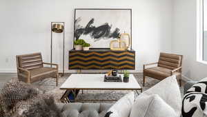 Living area with baseboards and wood finished floors