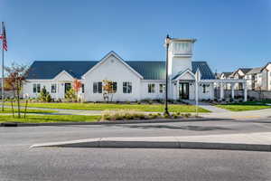 View of front of house featuring a standing seam roof, a front yard, and metal roof