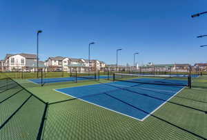View of sport court with a residential view and fence