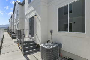 Exterior space featuring cooling unit, a mountain view, and stucco siding