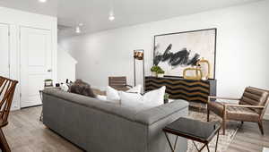 Living room featuring baseboards, recessed lighting, and wood finished floors