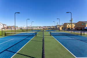 View of sport court featuring fence and a residential view