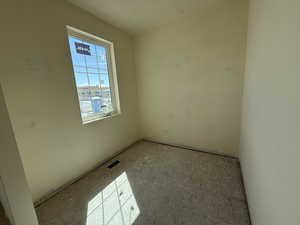 Unfurnished room featuring visible vents
