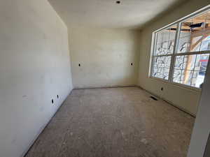 Unfurnished room featuring visible vents