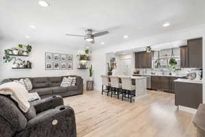 Living area with crown molding, light wood-type flooring, a ceiling fan, and recessed lighting