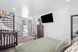 Bedroom with door to the back yard and access to the upstairs