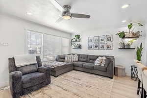 Living room featuring visible vents, ornamental molding, ceiling fan, recessed lighting, and wood finished floors