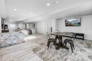 Dining area with wood finished floors, baseboards, and recessed lighting