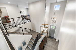 Entryway featuring a chandelier, recessed lighting, baseboards, and wood finished floors