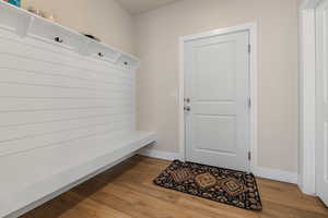 Mudroom featuring light wood-type flooring and baseboards