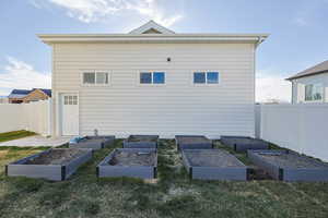 Rear view of property with a garden and fence