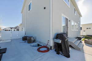 Back of house with a patio, central AC unit, stucco siding, and fence