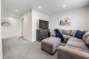 Living room featuring recessed lighting, baseboards, and carpet floors