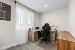 Carpeted office featuring recessed lighting, visible vents, and baseboards