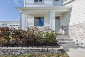 Doorway to property with stone siding