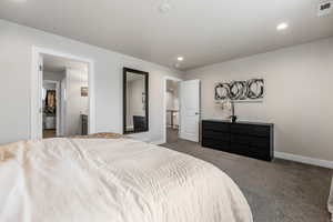 Bedroom featuring dark carpet, baseboards, visible vents, and recessed lighting
