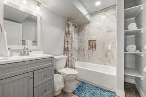 Full bath featuring shower / bath combo, vanity, and toilet
