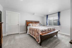 Carpeted bedroom with baseboards and recessed lighting