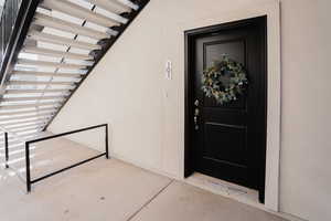Doorway to property with stucco siding