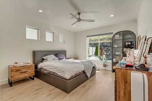 Bedroom with recessed lighting, light wood-style flooring, and baseboards