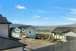 Exterior space featuring a residential view, stucco siding, and a mountain view