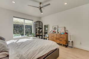 Bedroom featuring baseboards, light wood finished floors, recessed lighting, and a ceiling fan