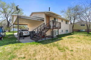 Exterior space featuring an attached carport and a front lawn