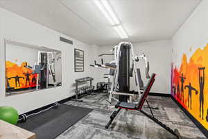 Workout area featuring visible vents, baseboards, and carpet floors