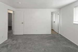 Empty room with baseboards and carpet flooring