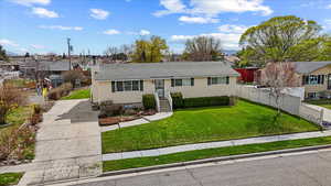 Split foyer home with roof with shingles, a front yard, a residential view, and fence