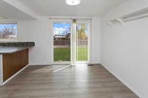 Unfurnished dining area featuring wood finished floors and baseboards