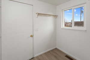 Interior space featuring light wood finished floors, visible vents, and baseboards