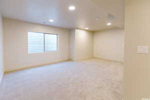 Unfurnished room with recessed lighting, visible vents, light colored carpet, and baseboards