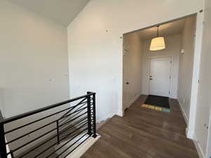 Interior space with baseboards and dark wood-style floors