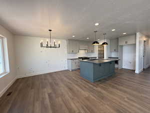 Kitchen with visible vents, baseboards, and a textured ceiling