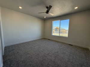 Spare room featuring a ceiling fan, baseboards, carpet floors, recessed lighting, and a textured ceiling