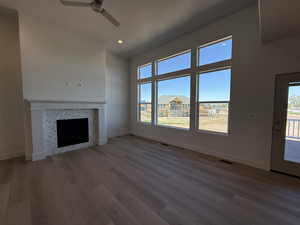 Unfurnished living room featuring a ceiling fan, healthy amount of natural light, baseboards, and recessed lighting