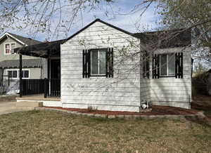 Single story home with a front yard and fence