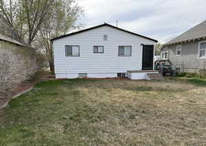 Back of house featuring a yard and fence