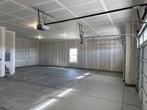 Garage with a garage door opener and electric panel
