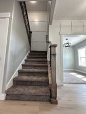 Stairway featuring wood finished floors and baseboards