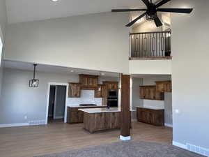 Kitchen featuring high vaulted ceiling, visible vents, and ceiling fan
