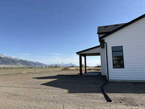 View of yard featuring a rural view and a mountain view